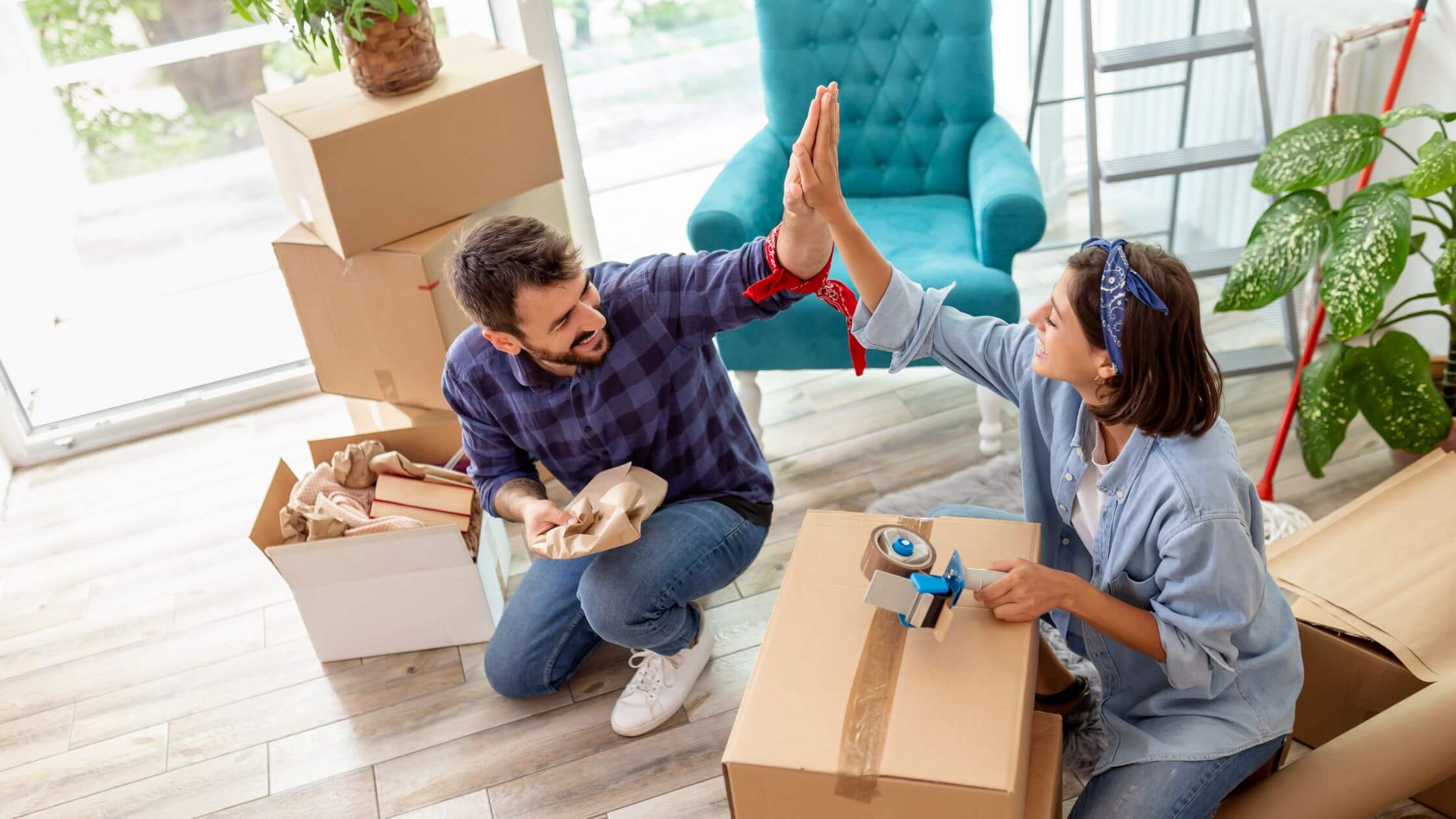 couple high-five while packing