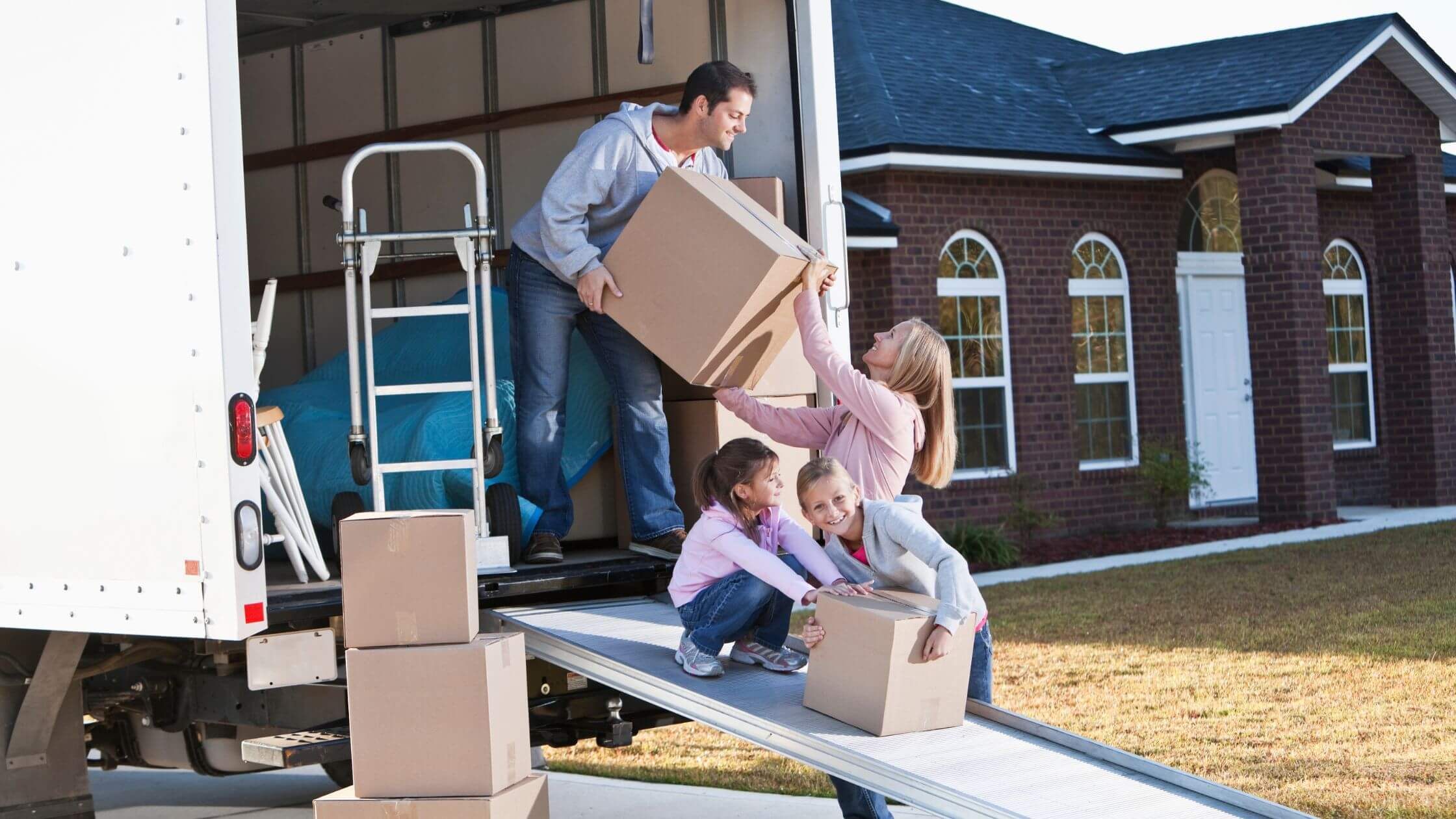 family moving boxes moving van